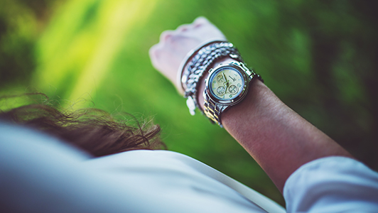 Girl looking at her watch.