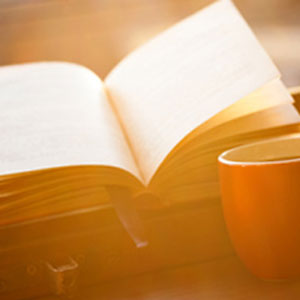 open book and coffee cup