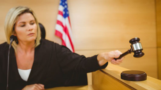 female judge placing judgement with gavel