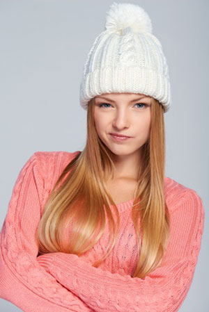 young woman in white hat not convinced