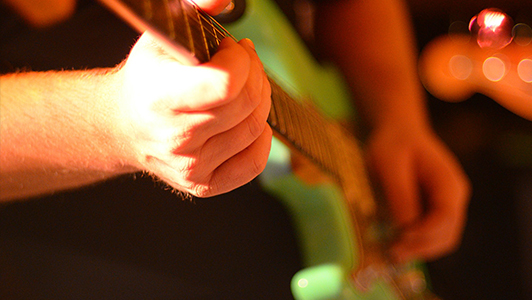 Guy playing an electric guitar.