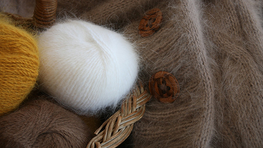 Fluffy wool threads in a basket.