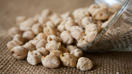 Chickpeas spilled from a bowl.