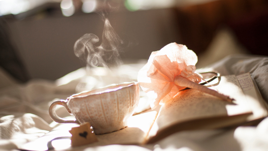 Tea cup standing on a notebook.