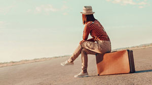 woman in hat on the moved sitting on box