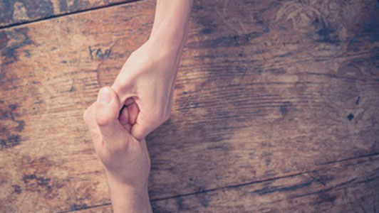 man and woman thumb wrestling