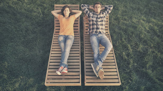 couple sitting on separate lawn chairs