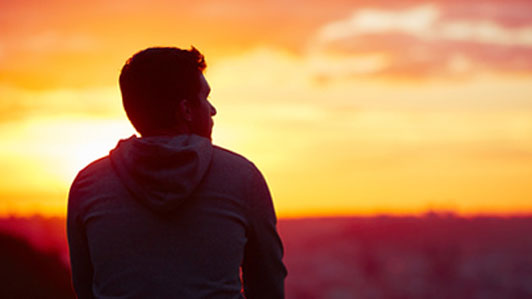 sunrise man sitting alone thinking