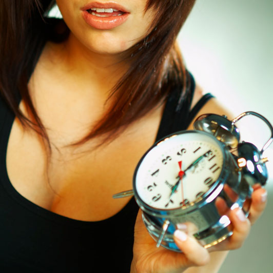 girl holding alarm clock