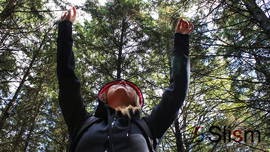 Happy girl among trees