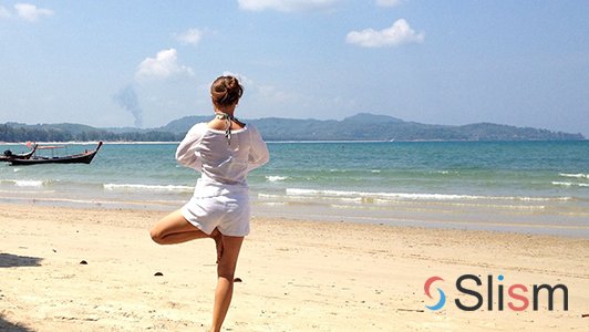 girl doing yoga on the beach