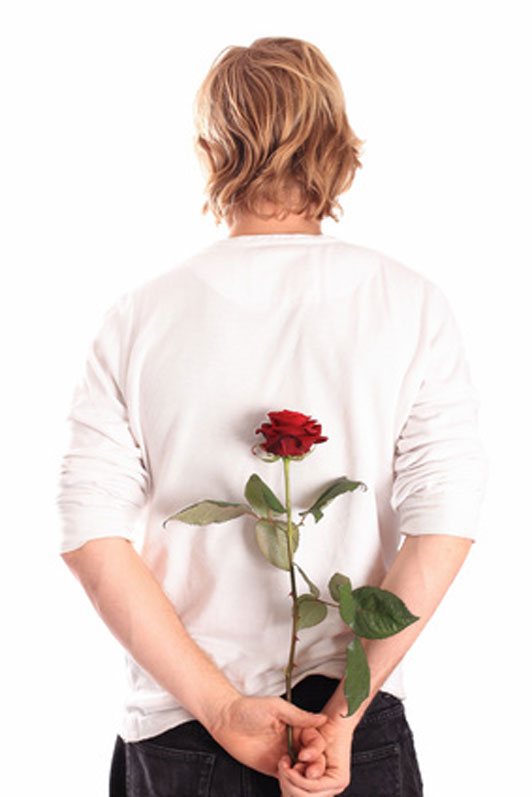 back of guy holding a rose