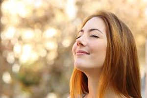 Woman smiling with her eyes closed