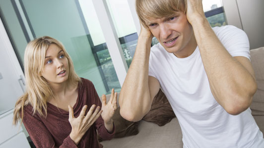 girl trying to tell guy who is not listening something