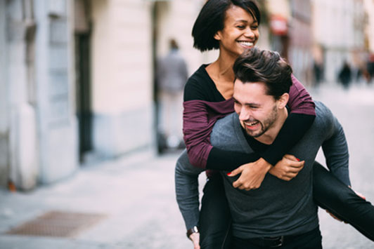 happy couple piggyback