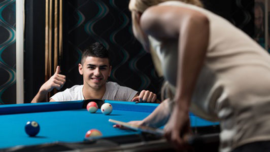 couple playing billiards