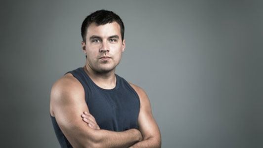 man in sleeveless with arms crossed