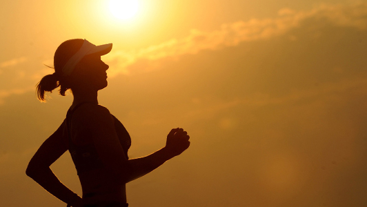 Girl jogging in sunny weather