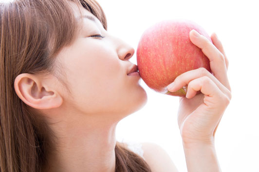 girl kissing apple