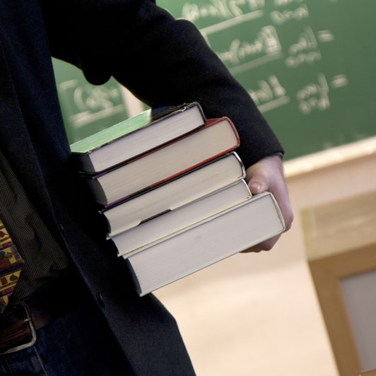 guy holding science books