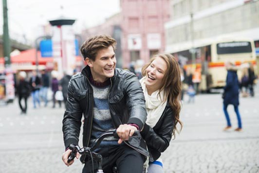 happy young couple on bike