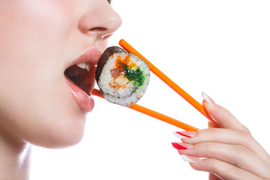 woman eating sushi