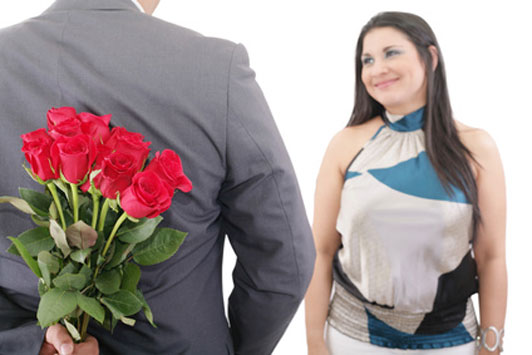 man surprising woman with flowers