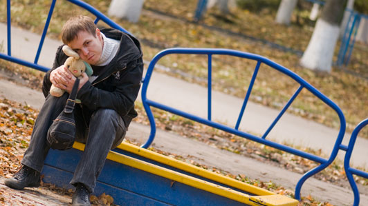 guy in park sitting on bench along