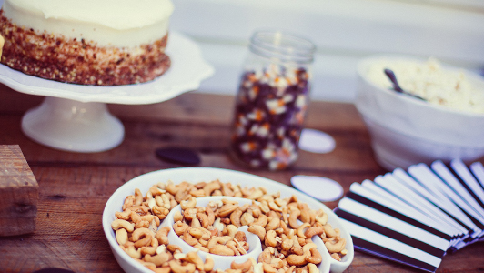 Cake and a bowl with peanuts.