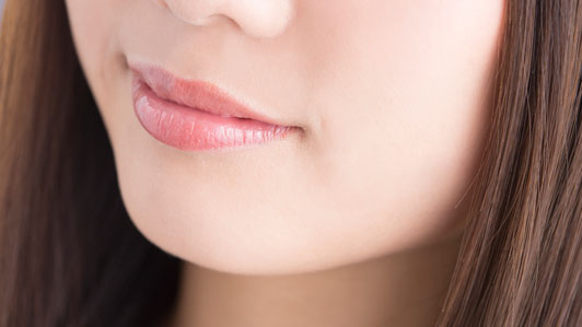 young woman with slight smile on face