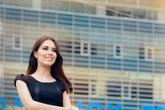 young business woman outside in front of building