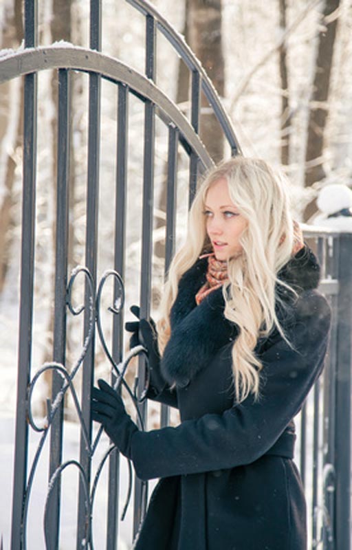 women wearing long black winter coat in winter