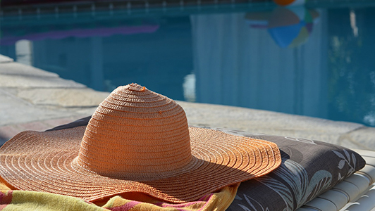 Hat near a pool