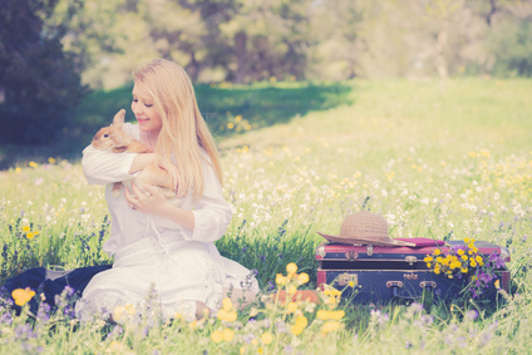 teenager girl with bunny in the nature