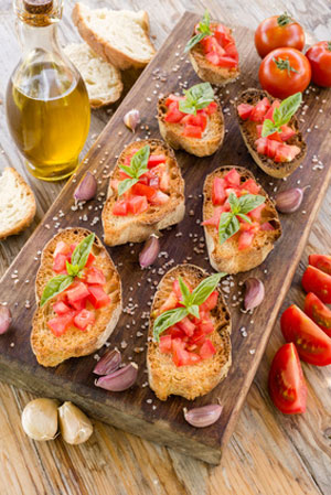 finger food with tomatoes on cutting board