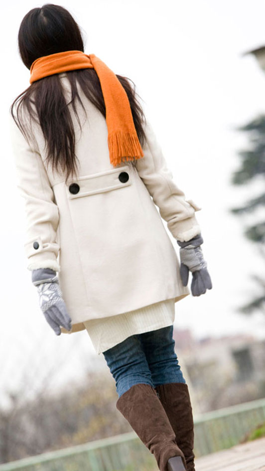 girl in orange scarf walking alone outdoors