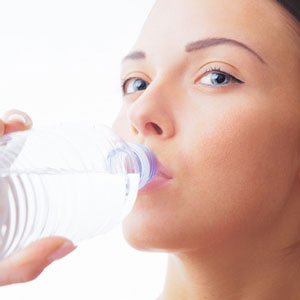 close up on face of woman drinking water