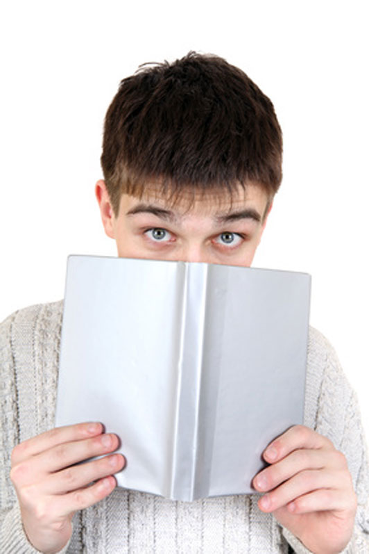 guy hiding behind book