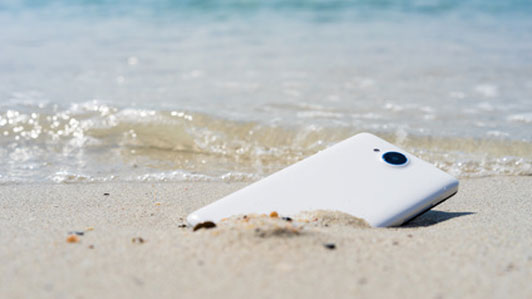 phone discarded in sand