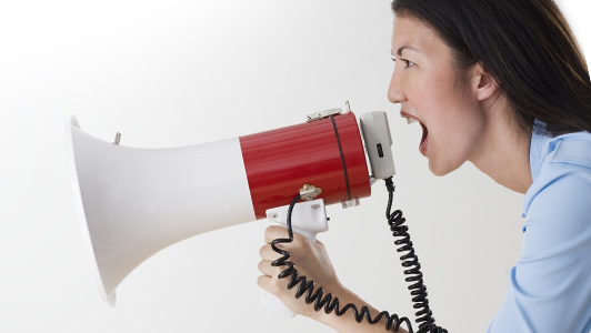 Woman with megaphone yelling.