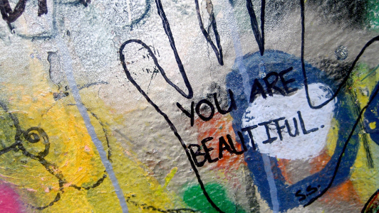 Grafiti shaped like hand saying 'You're beautiful'.