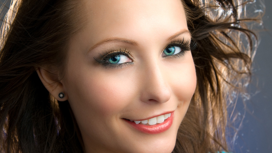 Girl with blue eyes smiling.