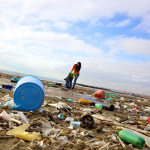 young woman picking up trash