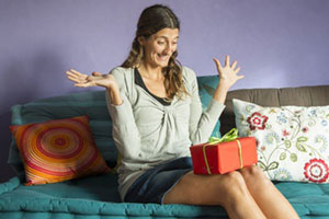 woman surprised receiving gift