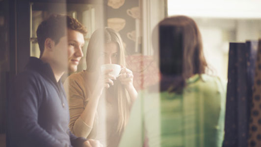 three friends talking in coffee shop