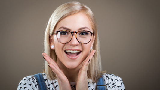 woman wearing glasses with happy facial expression