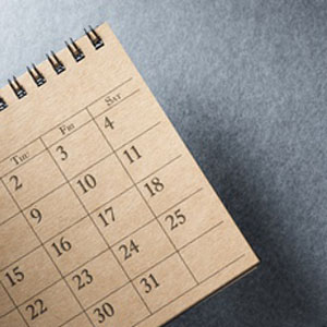 brown desk calendar on grey background