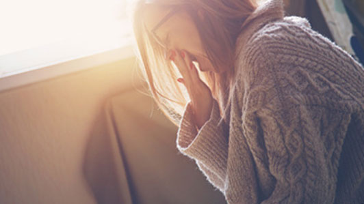 woman waking up yawning