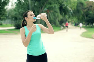 woman jogging drinking water