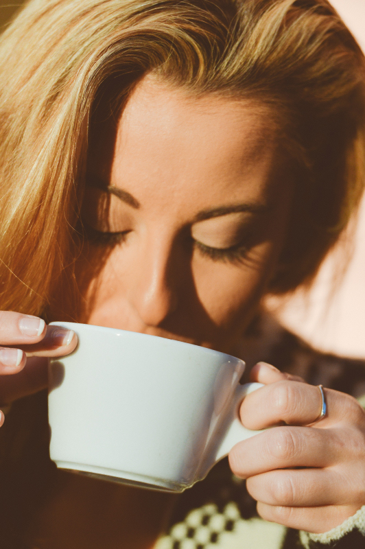 Young woman drinking coffee.